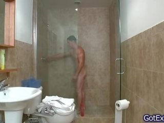 Splendid muscled guy jerking under shower